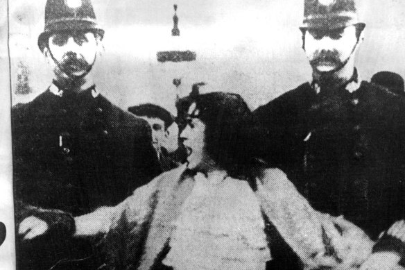 Feminist Christabel Pankhurst is led away by a London policeman.