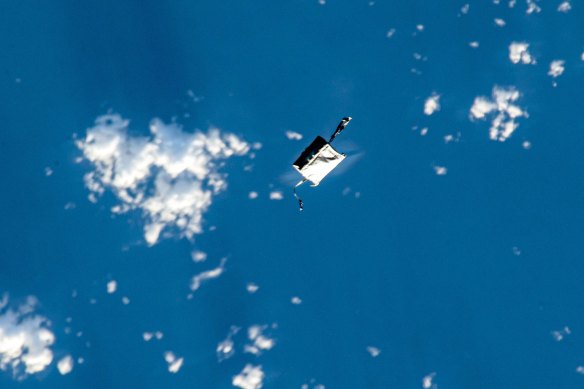 This photograph taken by a Japanese astronaut aboard the ISS shows the lost tool bag over Earth.