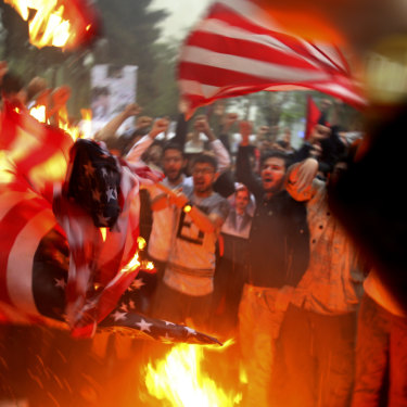 Iranian demonstrators burn representations of the US flag during a protest in front of the former US Embassy after Donald Trump pulled the US out of the nuclear deal.