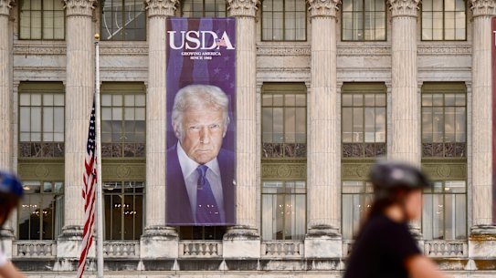 Banners showing the faces of US Presidents Donald Trump and Abraham Lincoln on the US Department of Agriculture building in Washington.
