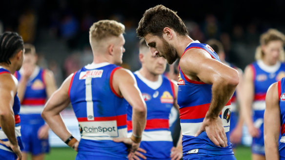 Marcus Bontempelli and Adam Treloar look dejected after the Bulldogs’ shock loss to the Hawks.