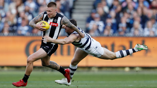 Jordan De Goey, who starred for the Magpies, is tackled by Patrick Dangerfield.