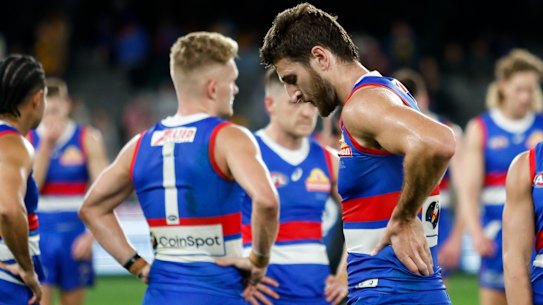Marcus Bontempelli and Adam Treloar look dejected after the Bulldogs’ shock loss to the Hawks.