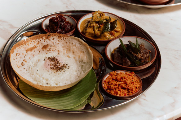 A hopper set, with an egg hopper (left), curries and sambols.