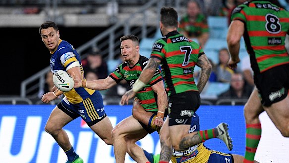 Mixed night at the office: Damien Cook offloads to Adam Reynolds against the Eels. The pass was ruled forward.