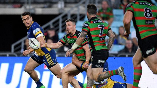 Mixed night at the office: Damien Cook offloads to Adam Reynolds against the Eels. The pass was ruled forward.