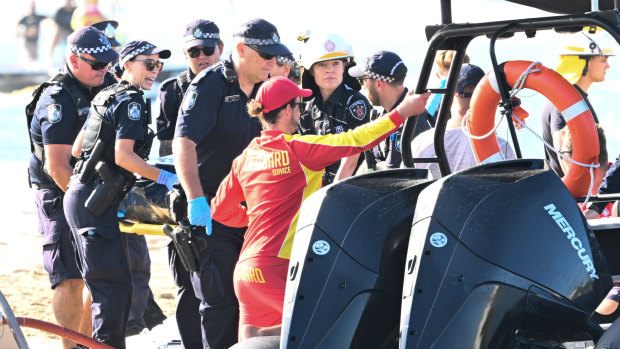 Emergency workers at the scene of the helicopter collision near Sea World.