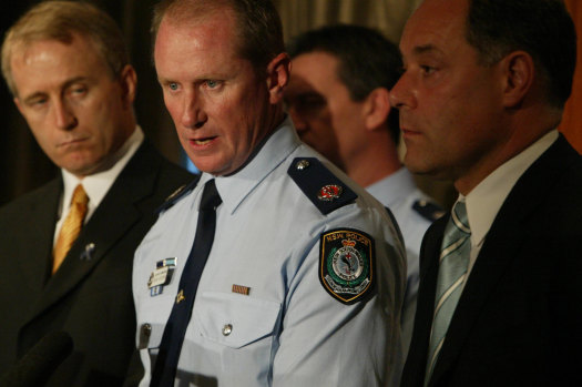 Minister Carl Scully (left) with Assistant Commissioner Mark Goodwin and Premier Morris Lemma.