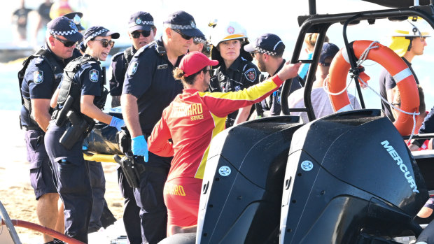 Emergency workers at the scene of the helicopter collision near Sea World.