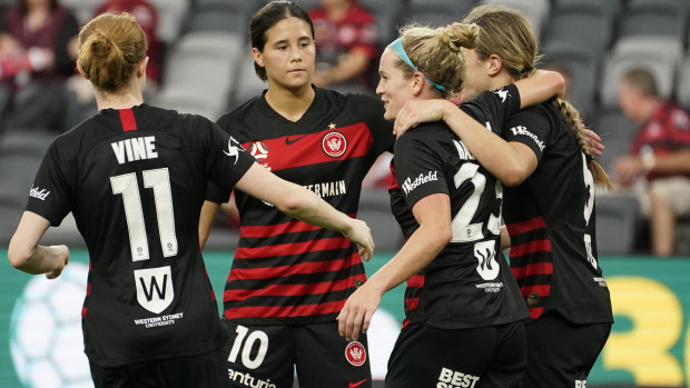 Western Sydney celebrate after Kristen Hamilton's effort was turned into the net by a Glory defender to clinch their 3-1 win.