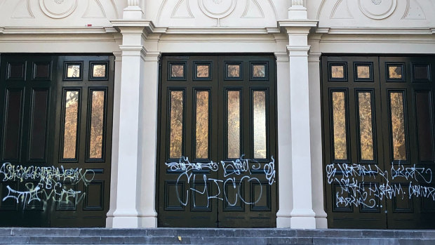 Graffiti on ceremonial front doors of the southern entrance of the Royal Exhibition Building. 