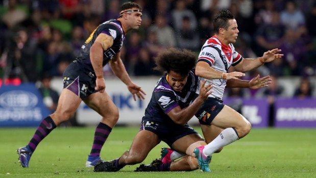 No love lost: Cooper Cronk tackled by Felise Kaufusi on Friday.