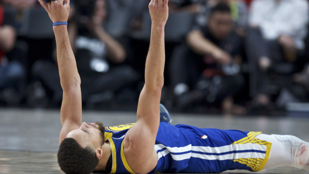 Steph Curry on the deck after being fouled and making a three-pointer in game three.