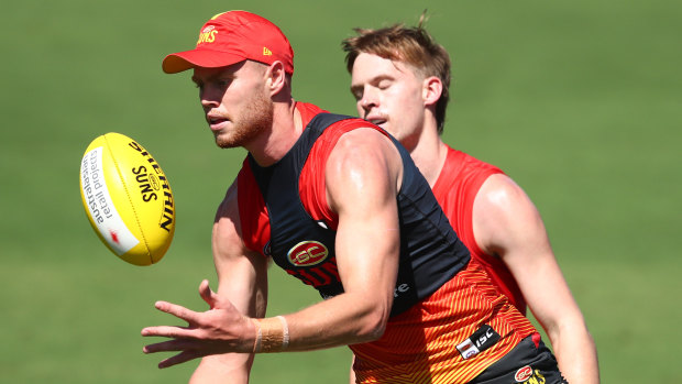 Peter Wright handballs at training.