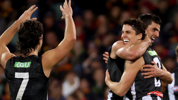 Trent Bianco celebrates a goal with Collingwood team mates Josh Daicos and Scott Pendlebury during the clash with the Crows at the Adelaide Oval.