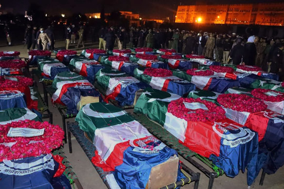 Security officials gather for funeral prayers of police officer, who were killed in the suicide bombing inside a mosque inside a police precinct, in Peshawar