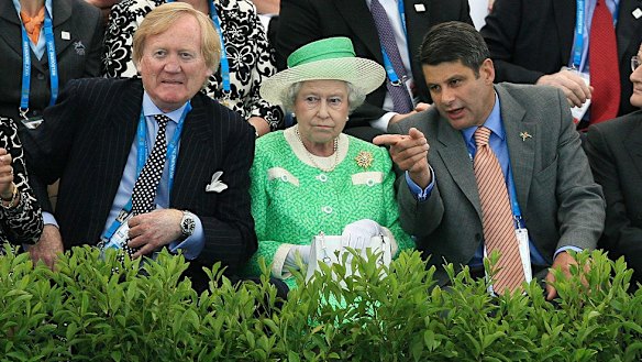 The Queen poolside with Ron Walker and then-premier Steve Bracks during the Commonwealth Games in 2006.