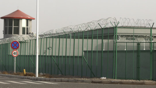 A guard tower and barbed wire fences are seen around a facility in the Kunshan Industrial Park in Artux in western China's Xinjiang region. People in touch with state employees in China say the government in the far west region of Xinjiang is destroying documents and taking other steps to tighten control on information. 