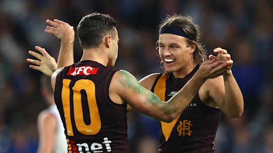Hawthorn celebrate a goal.