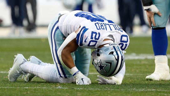 Dallas Cowboys player Tony Pollard on the ground following a hip-drop tackle that tore his ligaments and fractured his fibula.