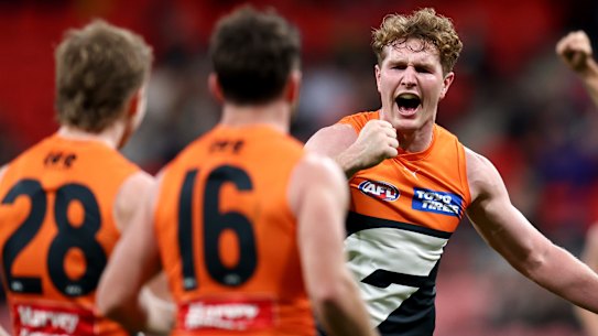 Giants teammates get around jubilant midfielder Tom Green.