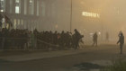 In this image taken from video, Pro-Palestinian protesters knock over a metal barrier, near the soccer stadium in Amsterdam.