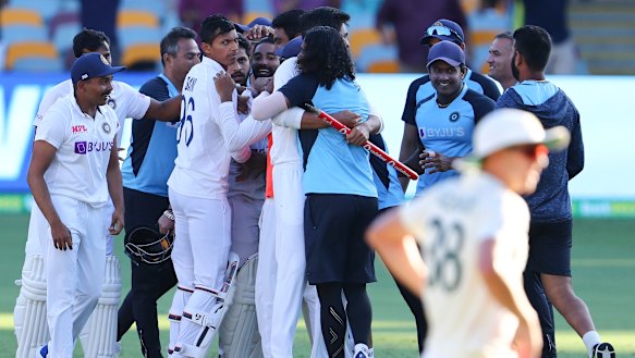 Indian players celebrate after defeating Australia by three wickets on the final day of the fourth Test.