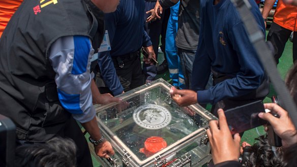 The box containing flight data is carried ashore on Thursday. 
