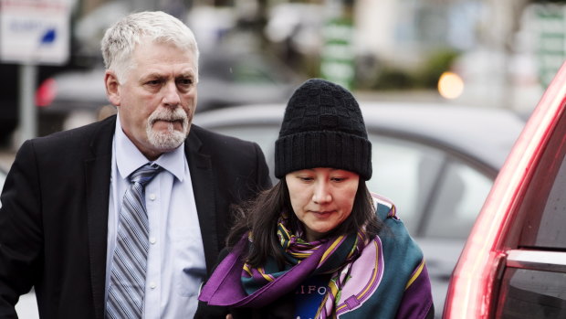 Huawei chief financial officer Meng Wanzhou arrives at a parole office with a security guard in Vancouver.
