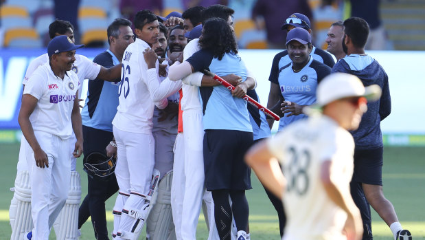 Indian players celebrate after defeating Australia by three wickets on the final day of the fourth Test.