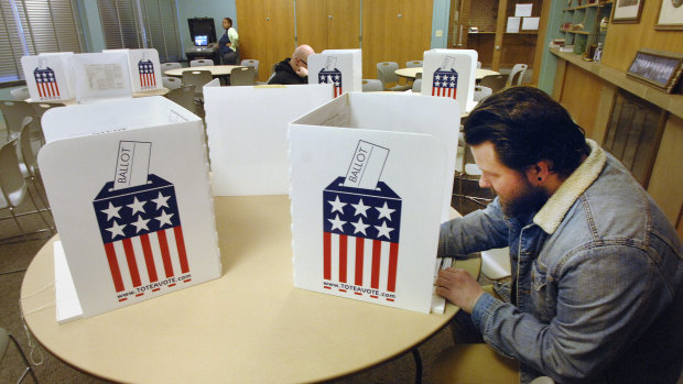 Kevin Dean marks his ballot during the Illinois primary.