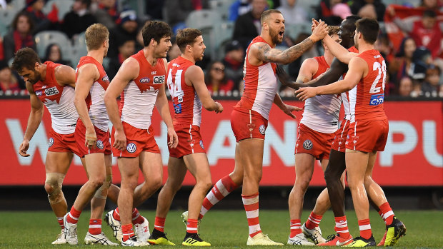 Bud time: Lance Franklin celebrates with the Swans after booting a goal against Melbourne.