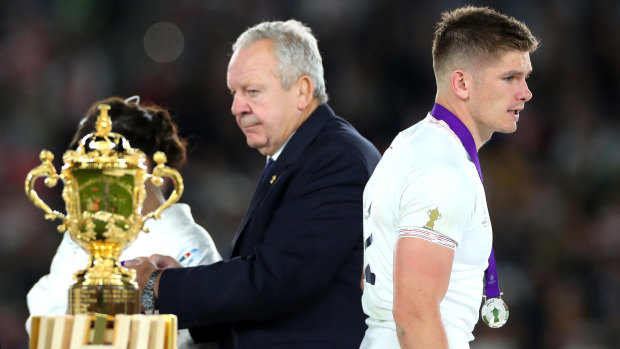 Flattered to deceive: Owen Farrell walks off the stage after receiving his silver medal as the Webb Ellis Cup goes in the other direction.