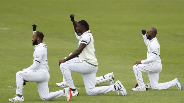 West Indies' captain Jasion Holder, centre, and teammates take a knee before the start of the Test match between England and West Indies at Southampton.
