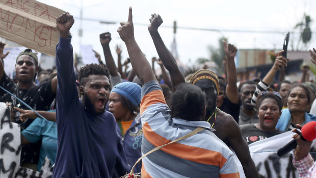 Papuans shout slogans during a protest in Timika, Papua province.