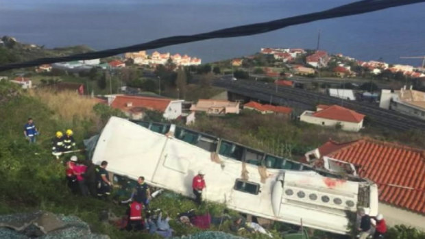 Emergency services attend the scene after a tour bus crashed at Canico on Portugal's Madeira Island.