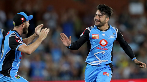 Early joy: Strikers bowler Rashid Khan (right) celebrates a wicket against the Renegades.