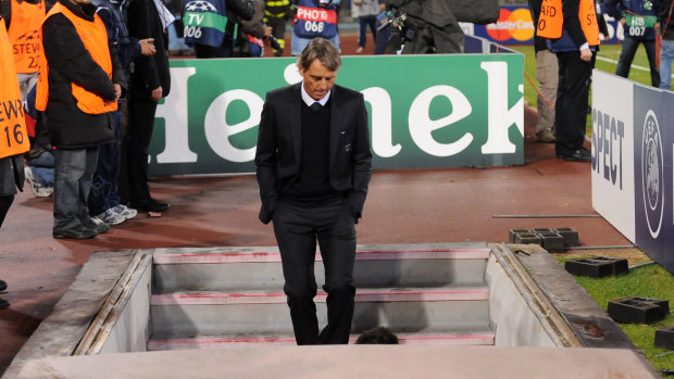 Scrutiny: Roberto Mancini leaves the field after a Champions League match back in 2011.