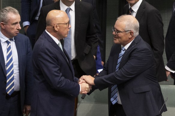 Opposition Leader Peter Dutton and former prime minister Scott Morrison shake hands after his valedictory speech.