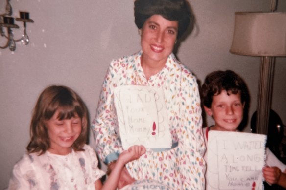 Rachel (left) and David welcoming their mother home from the hospital with homemade cards.