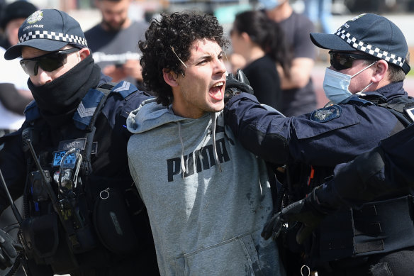 Police arrest a demonstrator on Saturday.
