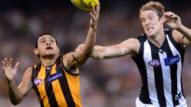 Hawk Cyril Rioli and Magpie Ben Reid battle for possession in 2012.