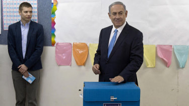 Israeli Prime Minister Benjamin Netanyahu, right, votes in Jerusalem in 2015, as his son Yair watches. Yair is no stranger to controversy, having been accused of living it up at taxpayers' expense.