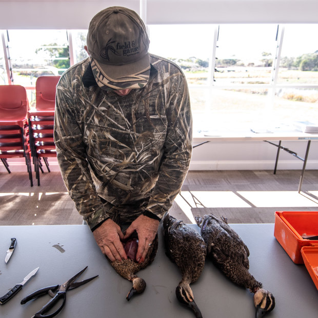 Hunter Trent Leen prepares the ducks for eating after the hunt.