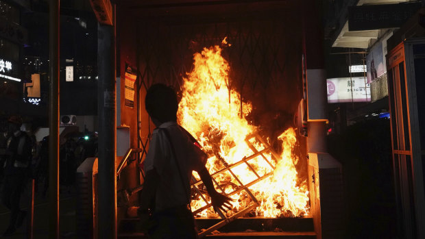 The entrance to a subway station is set on fire during a protest in Hong Kong on Sunday.