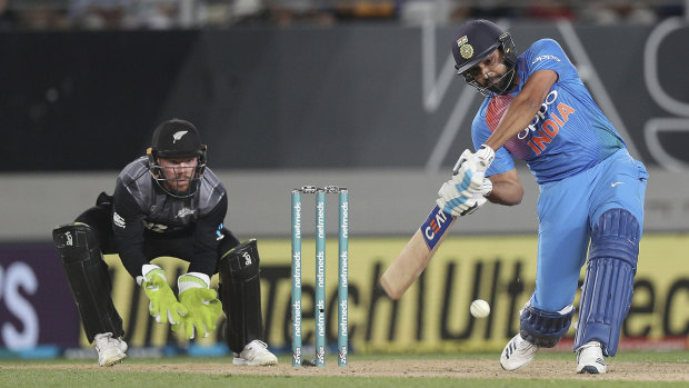 Heave: India's Rohit Sharma advances down the pitch.