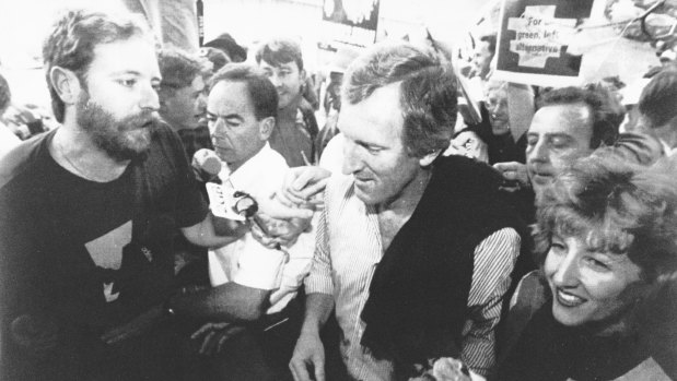 Security struggle to keep a protester from accosting John Hewson during his visit to Hobart's Salamanca Market on February 21, 1993.