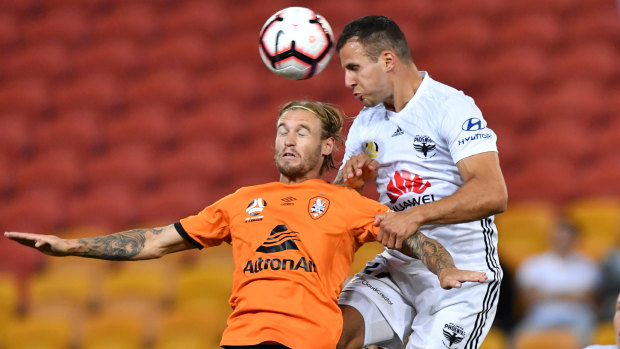 Steven Taylor (right) of the Phoenix heads the ball past Jacob Pepper (left) of the Roar to score a goal during the Round 25 A-League match at Suncorp Stadium on Friday.