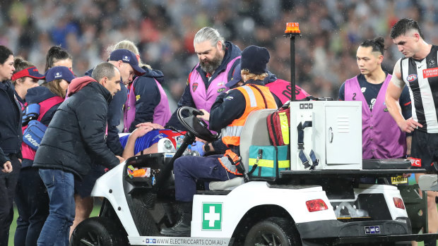 Brayden Maynard watches on as Angus Brayshaw is stretchered off the field.