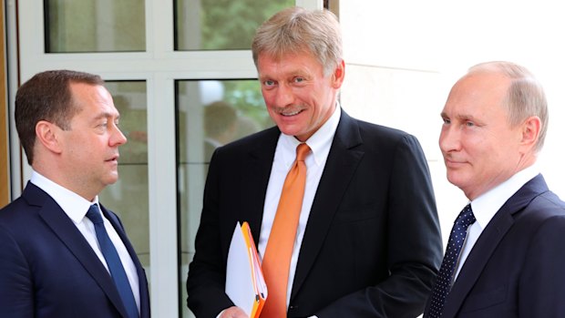 Dmitry Peskov, centre, flanked by Russian Prime Minister Dmitry Medvedev and Russian President Vladimir Putin last May.